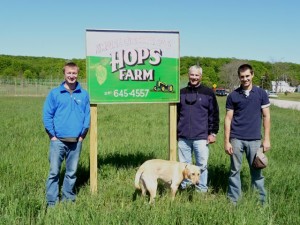 Empire Orchards’ Matt Wiesen, his father Dan Wiesen, and Zack Stanz  in front of their 5-acre hops farm off M-72 and Fredrickson Rd. in Empire.  Not pictured are partners John Stanz (Zack’s dad) and Mike Wiesen.